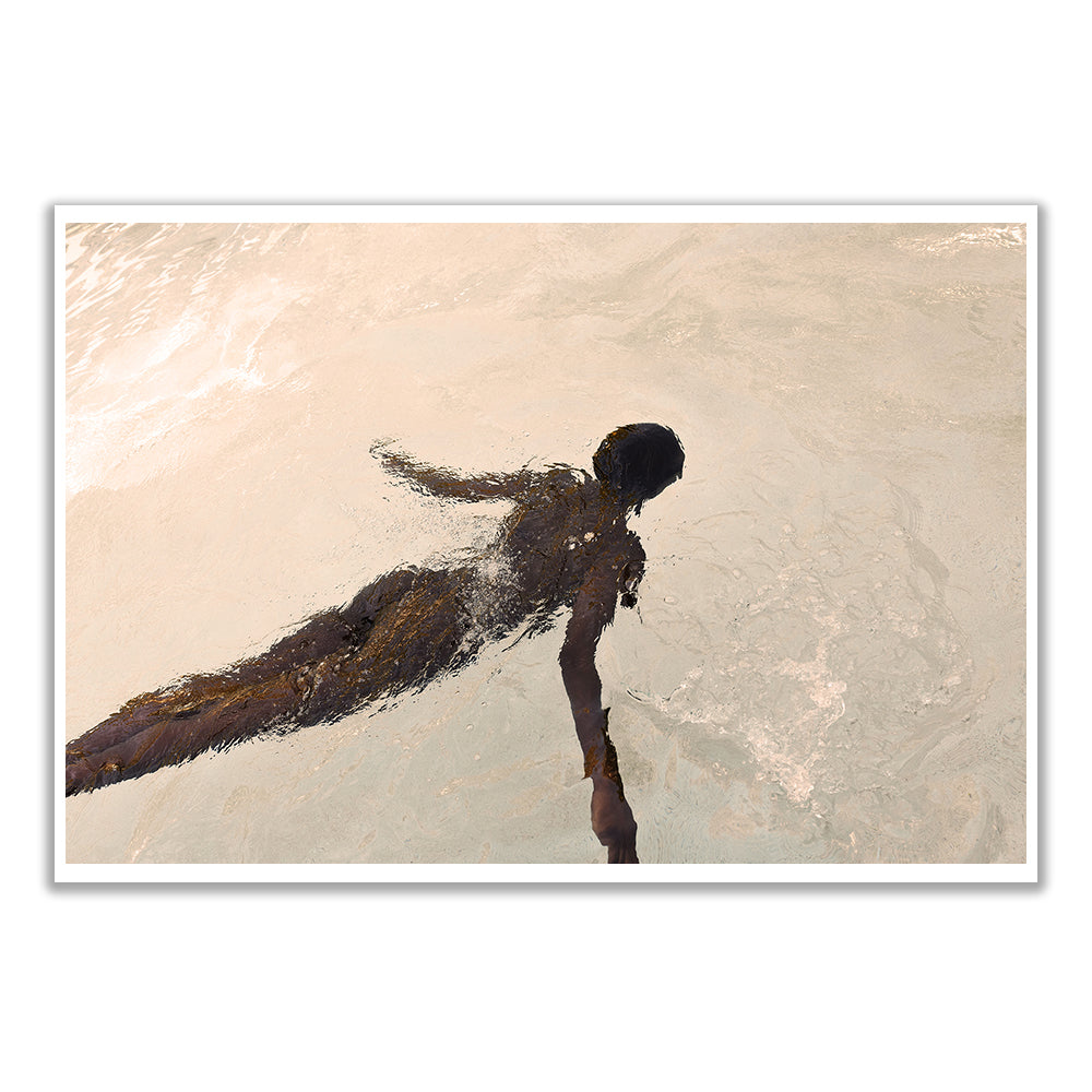 A person swimming near the surface casts a wavy reflection above, resembling the delicate texture of Francesca Owen's Elegance #3 fine art paper. The gentle ripples and warm lighting evoke a serene, custom-made moment as viewed from above.