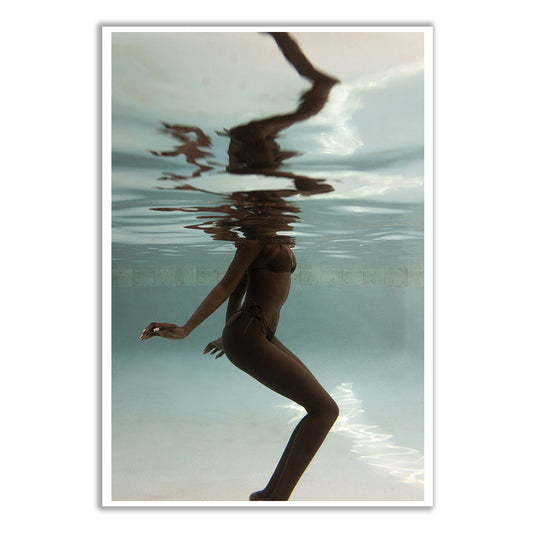 In a scene evocative of Francesca Owen's "Elegance #4," someone in a bikini stands underwater in a pool, where reflections dance with fluid, distorted imagery on the surface, akin to art rendered on fine art paper using archival pigments to preserve its ethereal beauty.