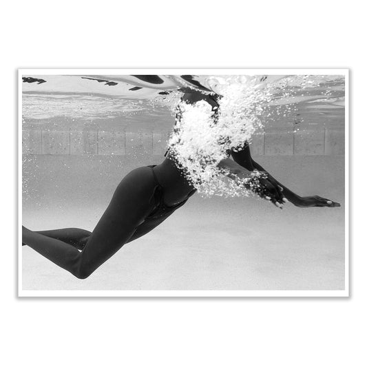 Elegance #5 by Francesca Owen is a custom-made, monochrome fine art print. Featuring a swimmer submerged underwater with extended legs and bent arms, bubbles enhance the dynamic pose. Beautifully hand-signed by the artist.