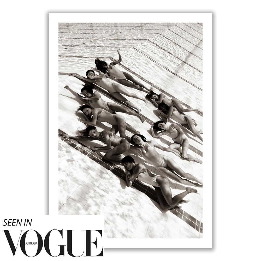 The black and white photograph titled "Ladies in Waiting #2" by Francesca Owen features 11 people lying on a structured surface with geometric shadows, evoking the spirit of Olympic Artistic Swimming. This artistic and stylized image, highlighted in Vogue Australia as a limited edition art piece, is known for its dynamic and abstract composition.