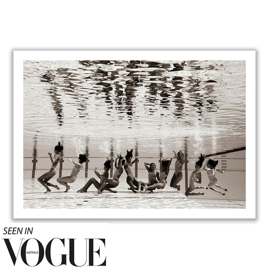 The image titled "Ladies in Waiting #5" by Francesca Owen captures a group of people underwater in a synchronized swimming pose, viewed from beneath, in striking black and white. This artwork is part of a Limited Edition collection and is printed on Giclee fine art paper. The text at the bottom reads "Seen in Vogue Australia.