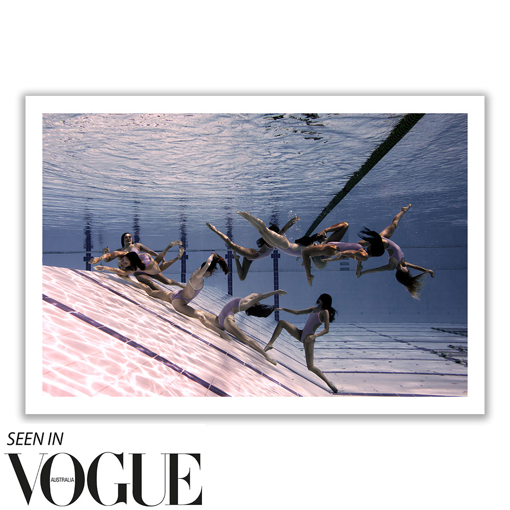 The underwater photograph features several synchronized swimmers in white swimsuits performing a graceful routine, beautifully capturing the fluidity against the pool's reflective surface. This artwork, titled "Ladies in Waiting #1 Colour" by Francesca Owen, is part of a Limited Edition collection printed on Giclee fine art paper. Text overlay: "Seen in Vogue Australia.