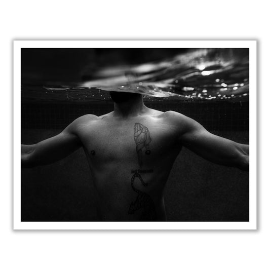 New Waters #1 by Francesca Owen features a black and white photograph of a shirtless person partially submerged in water with their arms spread outward. A snake tattoo decorates the left side of their chest, while the water's surface obscures their face. This striking image is printed on fine art paper and is available with worldwide shipping.